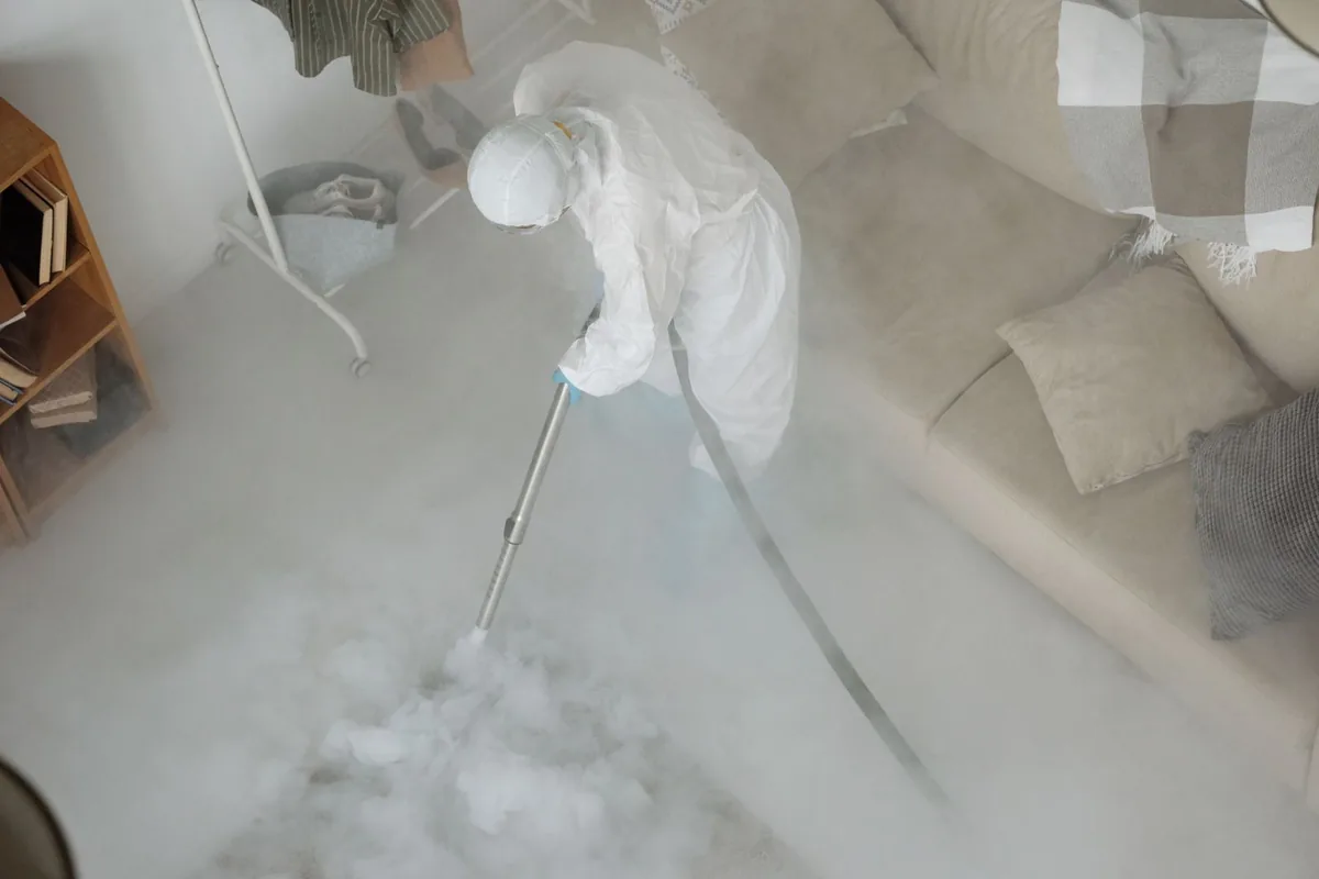 Biohazard cleanup technician in protective equipment, Pensacola Station, FL